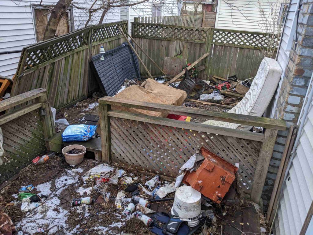 Household junk on rotten backyard deck