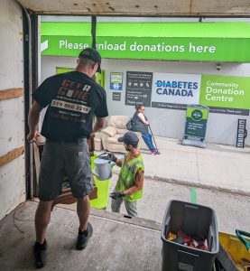 Mike Metcalfe from get r gone junk removal donating items to a local charity 
